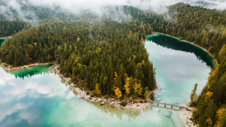 Autumn in the Bavarian mountains, Germany. Alps landscape with lake, bridge, view from above. Aerial drone photo.の写真素材