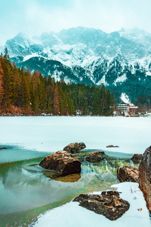 Winter alpine landscape in German forest. Eibsee lake in Bavarian mountains