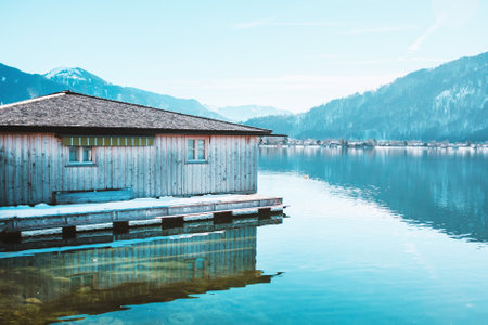 Wooden fishing house on the coast of the lake Tegernsee. Alpine mountains in Bavaria. Beautiful landscape in Germanyの写真素材