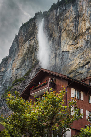 Lauterbrunnen valley, Switzerland. Swiss Alps. Cozy small house in mountains, waterfall. Forest and rocksの写真素材