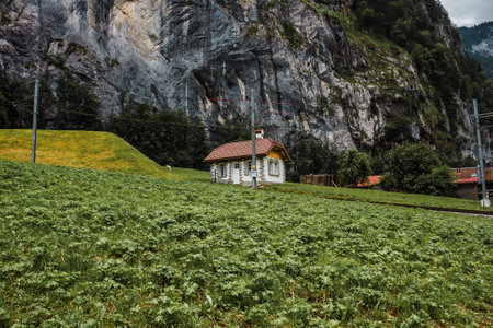 Lauterbrunnen valley, Switzerland. Swiss Alps. Small house in mountains. Forest, rocks and green meadows. Railway Jungfraujoch.の写真素材