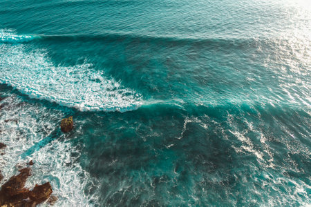 Turquoise waves and white foam of the sea, background. The waves of the ocean, Bali. Water textureの写真素材