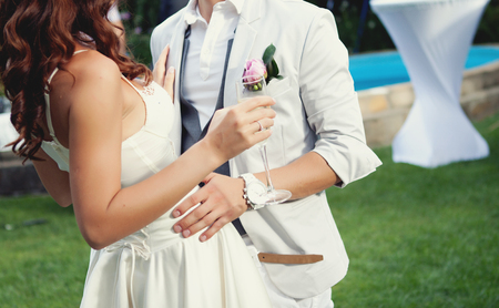 Happy bride and groom. Bride holding a glass of champagne.の写真素材