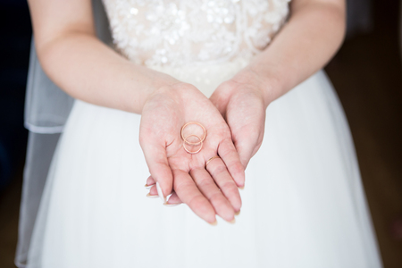 The bride is holding engagement rings. Close-up.の写真素材