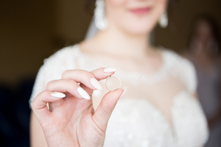 The bride is holding a wedding ring. Close-up.の写真素材