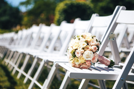 Wedding bouquet on white chairs. Close-up.の写真素材