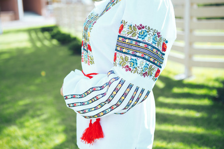 Beautiful young woman in traditional ethnic ukrainian  style. Vyshivanka blue with white embroidery