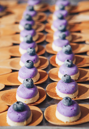 Exclusive blueberry cupcakes handmade. Variety of delicious party dessert food.の写真素材
