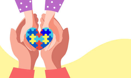 Heart puzzle symbol of autism in human hands. Concept for world autism day, help support children...