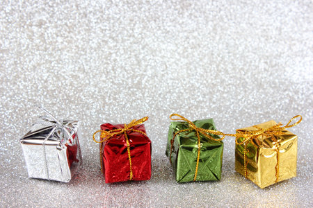 Gifts on a silver glitter background with copy space. Holiday concept, New Year and Christmas background for design.の写真素材