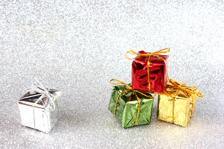 Gifts on a silver glitter background with copy space. Holiday concept, New Year and Christmas background for design.の写真素材