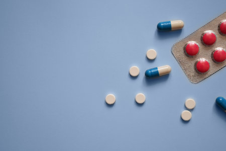 pills and capsules on a blue background, medication, medical workers day, medical care, banner for...