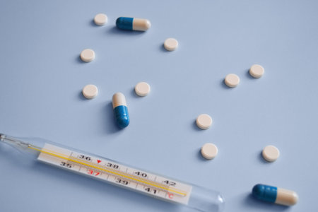 thermometer, capsules and tablets on a blue background, medication, medical workers day, medical care, banner for hospital, template for textの写真素材