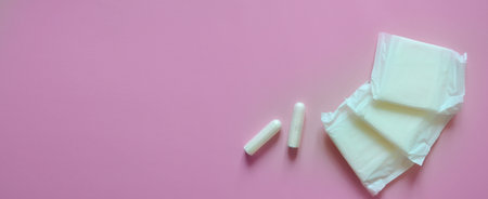 tampons and pads on a pink background, intimate hygiene, womens hygiene, menstruation and critical days, womens health, bannerの写真素材