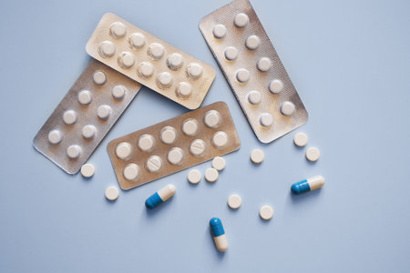 capsules, tablets and pill packs on a blue background, medication, medical workers day, medical...