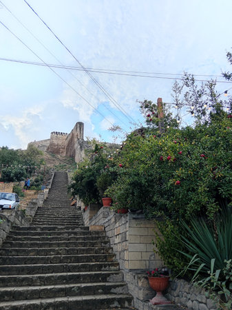 stone steps of the ancient fortress of Naryn-Kala, Derbent, Republic of Dagestan, Russia, pomegranate trees with ripe red pomegranates, cloudy summer dayの写真素材