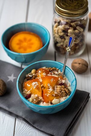 Persimmon oatmeal with nutsの写真素材