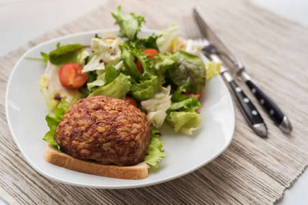 Beef cutlet with salad and wineの写真素材
