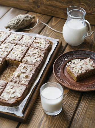 Pumpkin pie with cream and almond petals on a wood backgroundの写真素材