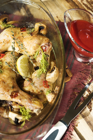 Roasted chicken legs with mushrooms and sauseの写真素材