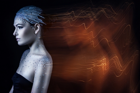 beautiful woman with rhinestones on her head surrounded by his soul.の写真素材