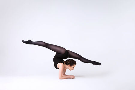 young girl performs gymnastic exercisesの写真素材