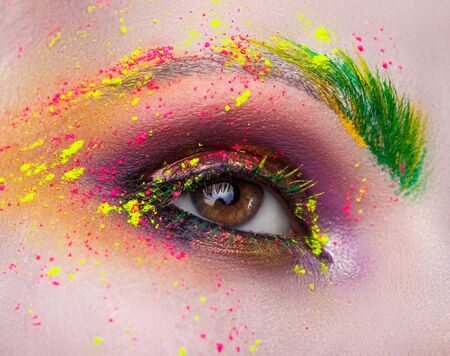 female eye with bright makeup closeupの写真素材