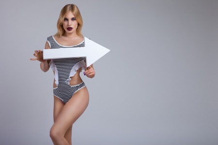 beautiful girl on a gray background with banners and arrowsの写真素材