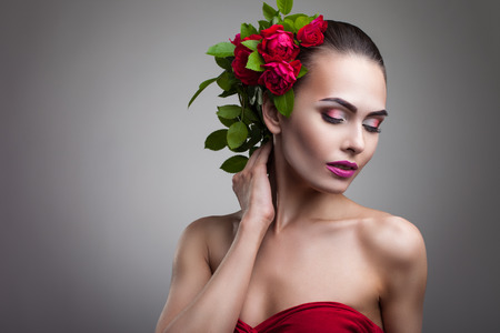 portrait of a woman with beautiful make-up and flowers on her headの写真素材