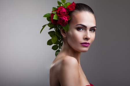 portrait of a woman with beautiful make-up and flowers on her headの写真素材
