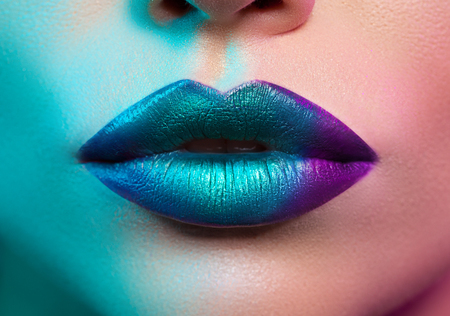 close-up of female lips with colored lightの写真素材