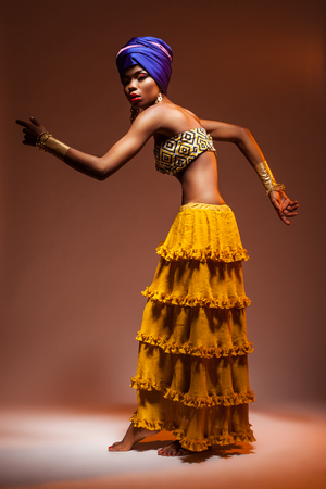 Dance hot African night, a beautiful woman in a bright dressの写真素材