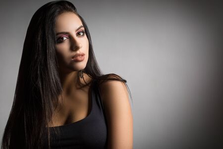 young and beautiful brunette with long hair and well-groomedの写真素材