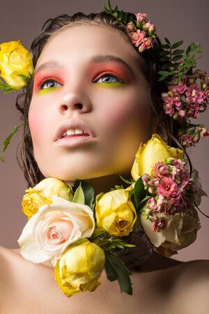 fading bouquet of flowers around the face of a young girlの写真素材