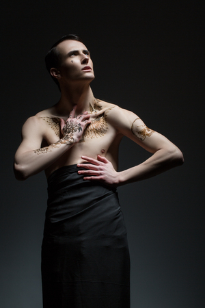 male portrait against a dark gray background, young elastic bodyの写真素材
