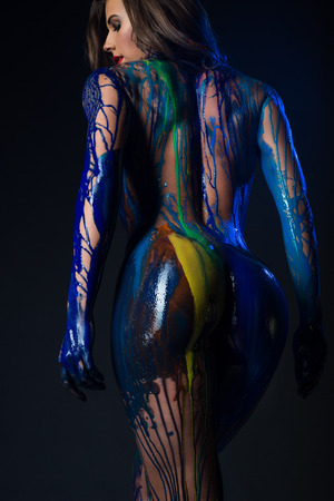 beautiful female body covered with paintの写真素材