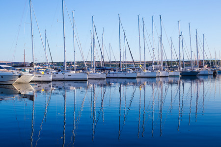 port in the morning, yachts moored in a row
