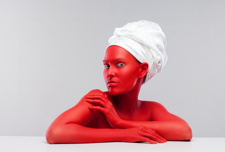 young girl painted red, little devil in the kitchenの写真素材