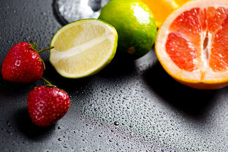fruits on a dark table, cut lime. vitamins all year roundの写真素材