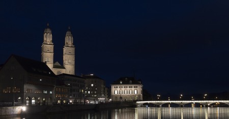 Grossmuenster church and Zurich city center by night. Switzerland.の写真素材