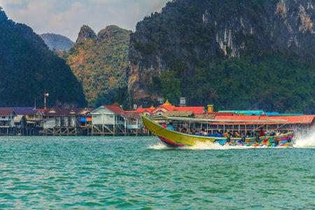Andaman Sea, Thailand - January 25th, 2014: Longtail boat on a ride in Thailand with limestone mountains in the backgroundのeditorial素材