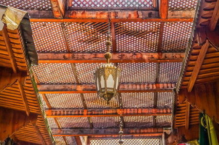 Traditional Moroccan lantern and cedar wood carved ceiling in Fez, Moroccoのeditorial素材