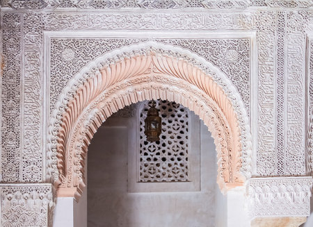 Fes, Morocco - May 11, 2013: Moroccan Carved Plaster Arabesque and mosaic in the 14th century  El Attarine Medersa in Fez, Moroccoのeditorial素材