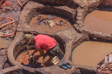 Fes, Morocco - May 11, 2013: Workers handling hides at a tannery in Fes, Moroccoのeditorial素材