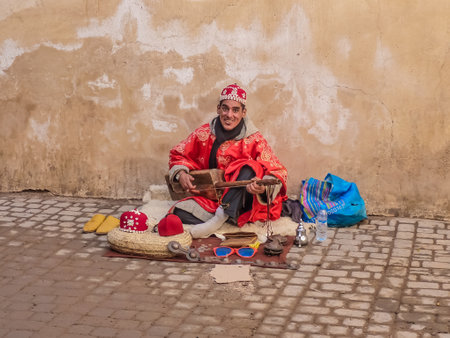 Marrakech, Morocco - December, 08, 2012: Moroccan Gnawa street musician playing gumbri inのeditorial素材