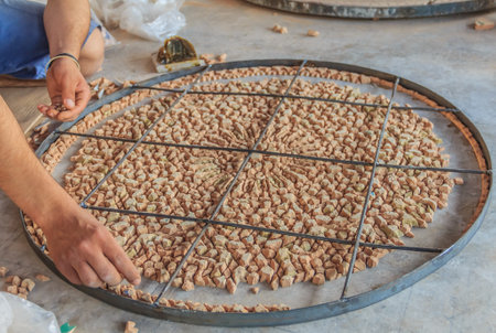Fes, Morocco - May 11, 2013: Moroccan mozaic artist at work in a pottery shopのeditorial素材