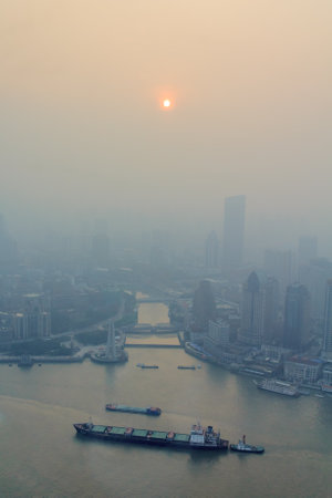 Shanghai, China - June 16, 2013: View of heavily polluted skyline over Huangpu river. Heavy air pollution has become common in many cities in China.のeditorial素材