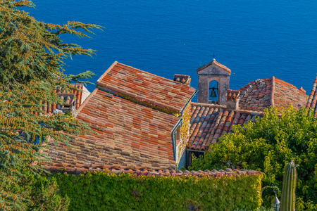 Scenic view of the medieval rooftops and bell tower from the top of the town of Eze village on the French Rivieraの写真素材