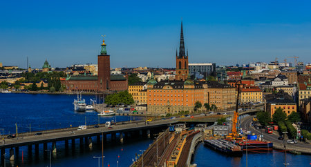 Panoramic view onto traditional gothic buildings in the old town, Gamla Stan; Riddarholmen island with burial church of Swedish monarchs and City Hall, Stadshuset, in Kungsholmen island in Stockholm, Swedenのeditorial素材