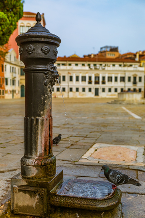 Antique ornate water pump in a courtyard in Venice Italyの写真素材